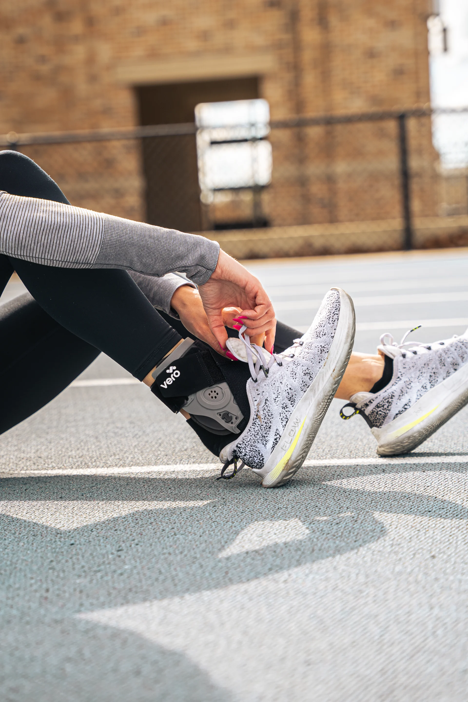 Man trying on a running shoe while wearing a Vero Ankle® Brace.